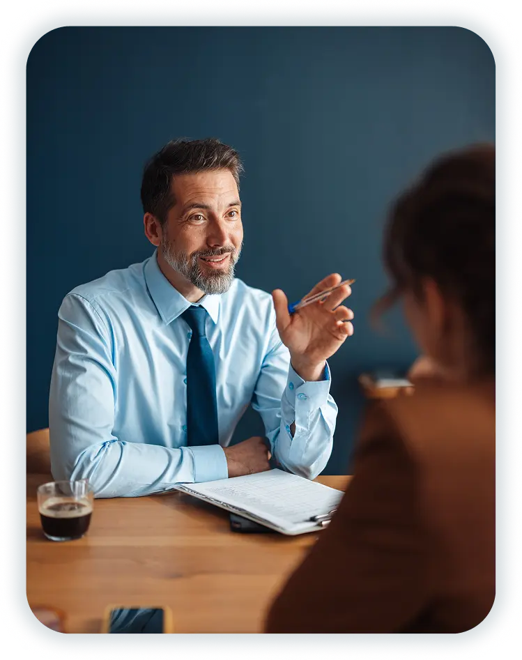 Wellcove representative speaking with a policyholder across a desk