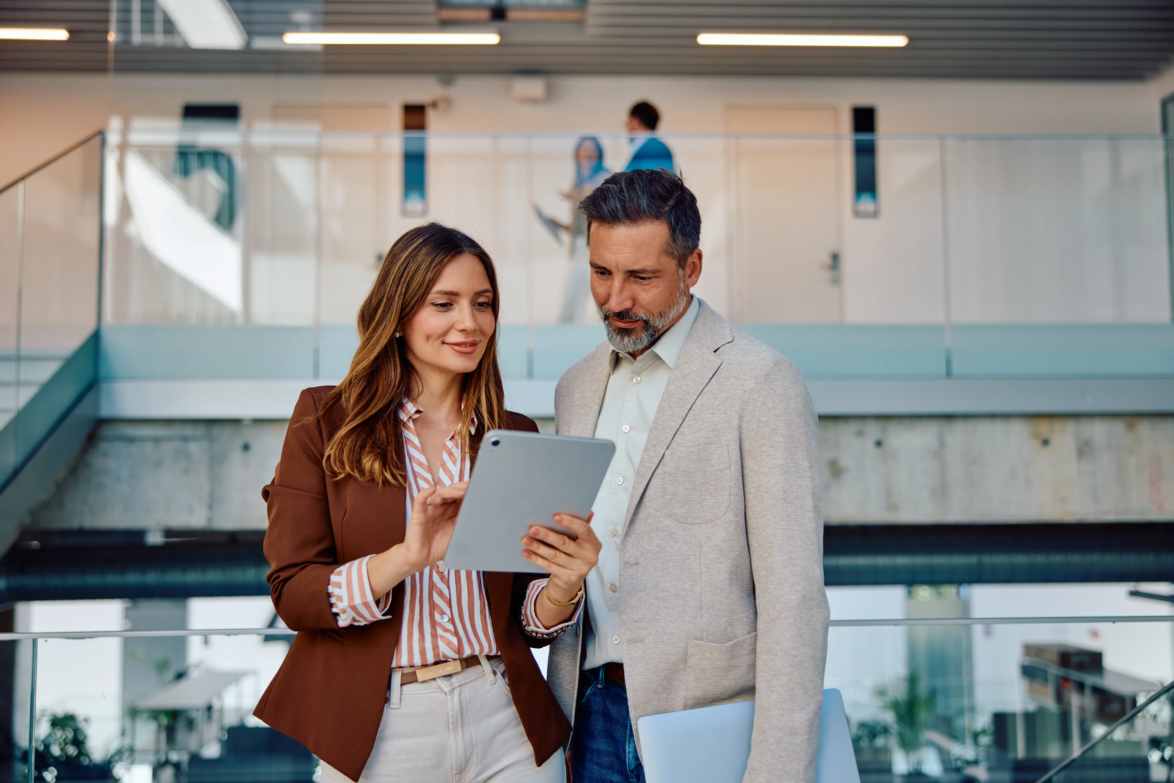 An insurance carrier team reviewing policyholder information together on a tablet
